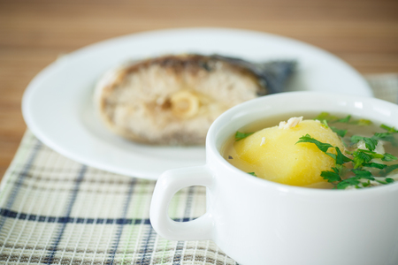 fish soup with vegetables and herbs in a bowlの写真素材