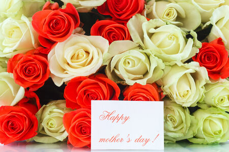 bouquet of red and yellow roses on a white backgroundの写真素材