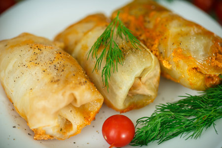 braised cabbage leaves wrapped rolls on a plateの写真素材