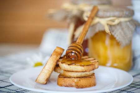 sweet fried toast with honey on the tableの写真素材