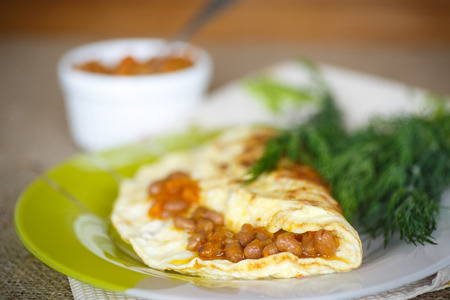 fresh morning egg omelet with beans and greensの写真素材