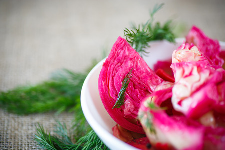sauerkraut with beets and spices in a white plateの写真素材