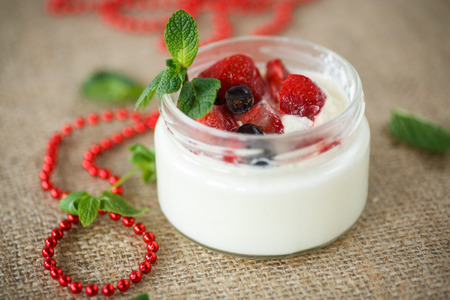delicious sweet yogurt with berries in a glass jarの写真素材