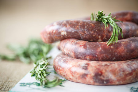 home hepatic raw sausage with rosemary on a tableの写真素材