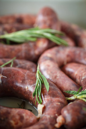 home hepatic raw sausage with rosemary on a tableの写真素材