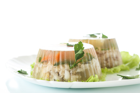 Jellied fish with egg and vegetables on a white backgroundの写真素材