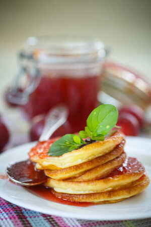 pancakes with plum jam on a plateの写真素材