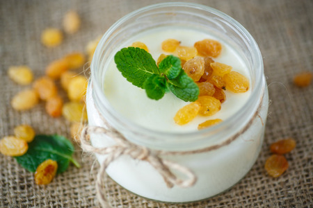 home sweet yogurt with raisins in a glass jarの写真素材
