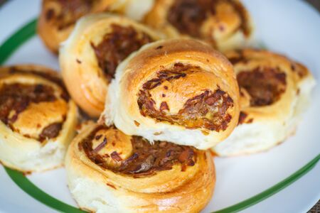 twisted pastry stuffed with cabbage on the tableの写真素材