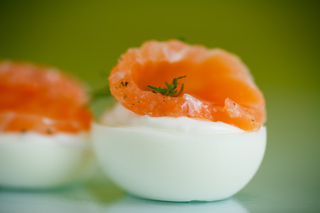 boiled eggs with slices of salted red fishの写真素材