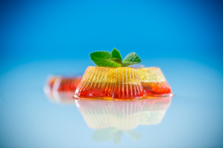 colorful fruit jelly sweets on a blue backgroundの写真素材