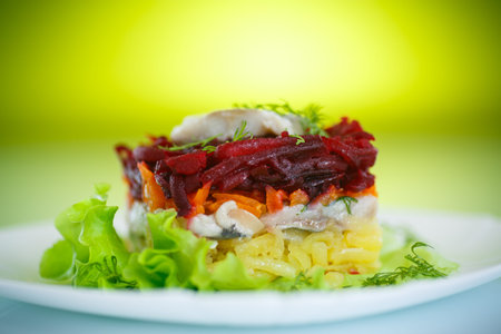 Russian traditional salad with herring and boiled vegetables