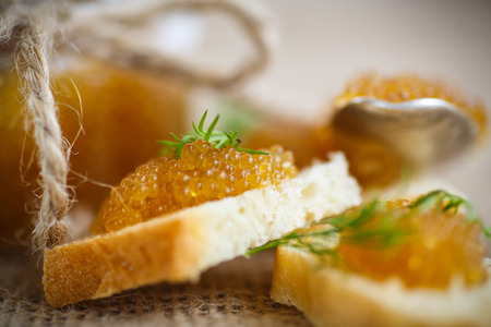 bread spread with salted pike caviar on the tableの写真素材