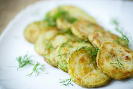 fried zucchini seasoned with dill in a bowlの写真素材