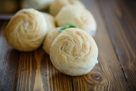 fresh baked rolls on the wooden tableの写真素材