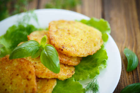 fried potato pancakes with herbs and basilの写真素材
