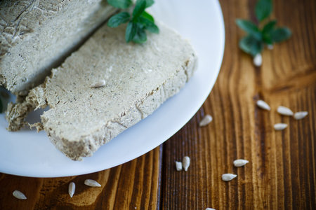cut piece of sweet halva with seeds on a plate