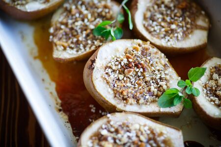 sweet pears baked with nuts and honeyの写真素材