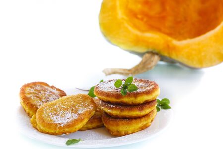 fried sweet pumpkin pancakes on a white backgroundの写真素材