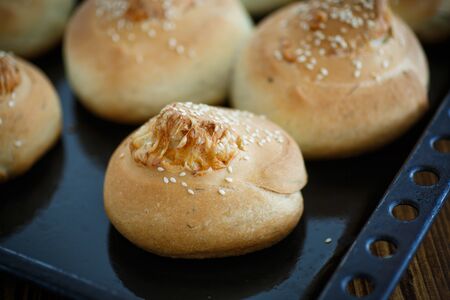 homemade bread loaf with cheese inside and sesame seedsの写真素材