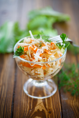 Sauerkraut with carrots and spices in a bowl on a tableの写真素材