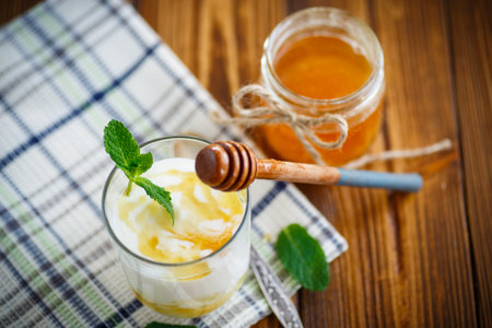 Greek yogurt with honey in a glassの写真素材