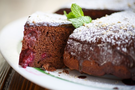 chocolate cake stuffed with cherries on a plateの写真素材