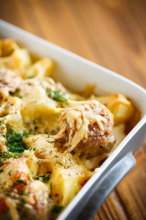 Vegetable casserole with potatoes and meatballs in a ceramic formの写真素材