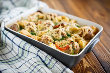 Vegetable casserole with potatoes and meatballs in a ceramic formの写真素材