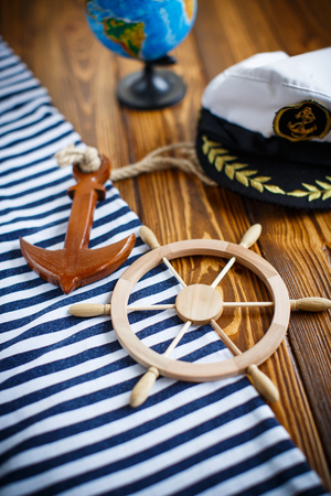 Decorative wooden steering wheel on an old wooden tableの写真素材