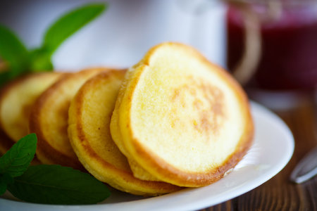 sweet pancakes with mint on a wooden table