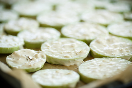 raw zucchini sauce on baking paper in a bakingの写真素材