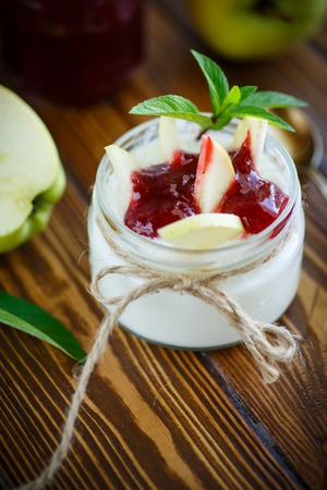 sweet homemade yogurt with apples and jam on the tableの写真素材