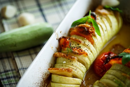 Baked zucchini stuffed with vegetables and baconの写真素材