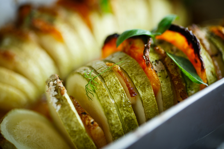 Baked zucchini stuffed with vegetables and baconの写真素材