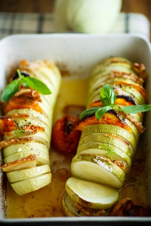 Baked zucchini stuffed with vegetables and baconの写真素材