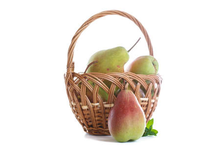 Ripe pears in a basket on a white backgroundの写真素材