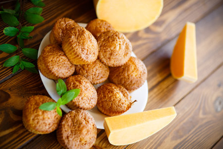 Sweet pumpkin muffins on a wooden table