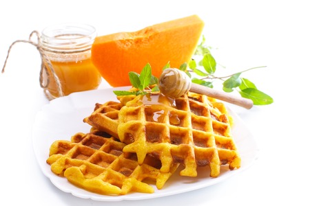 pumpkin waffles with honey on white backgroundの写真素材