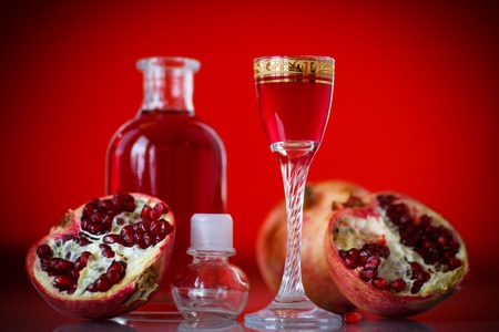 sweet pomegranate alcoholic cordial in the decanter with a glassの写真素材