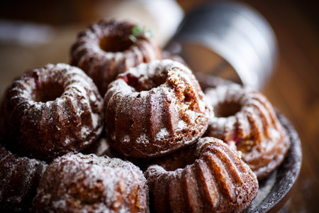 sweet honey muffins in powdered sugarの写真素材