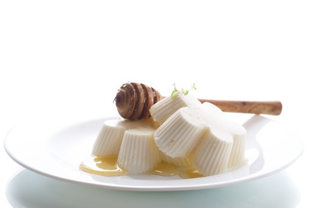 sweet dessert panna cotta with honey on a white backgroundの写真素材