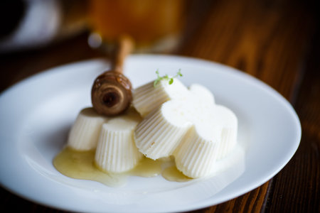 sweet dessert panna cotta with honey on a wooden tableの写真素材