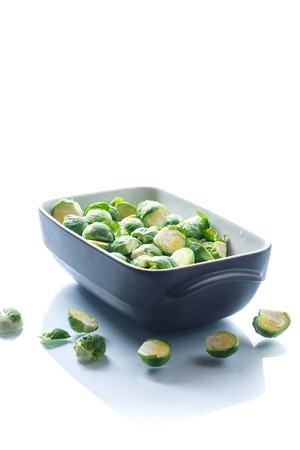 raw Brussels sprouts in ceramic formの写真素材