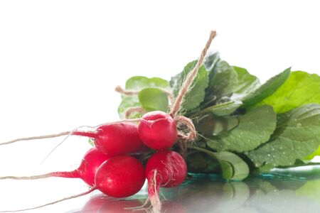 Ripe red radish with foliageの写真素材