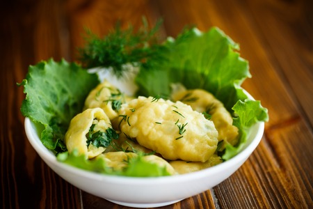Dumplings stuffed with potatoes with green onions in a plateの写真素材