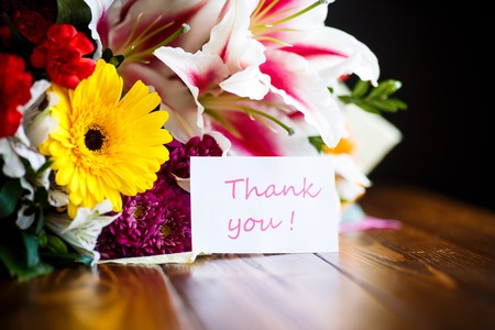 beautiful bouquet of different flowers on a wooden tableの写真素材