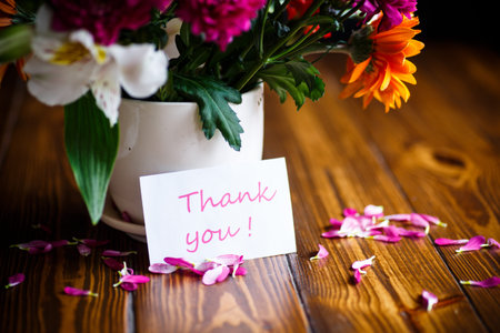 beautiful bouquet of different flowers on a wooden table
