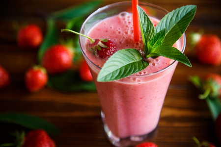 strawberry fresh sweet smoothies in a glass on the tableの写真素材