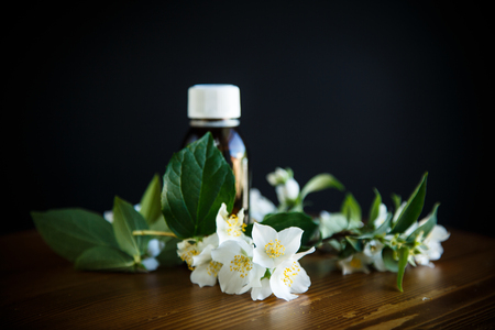 Essential aroma oil with jasmine on wooden backgroundの写真素材